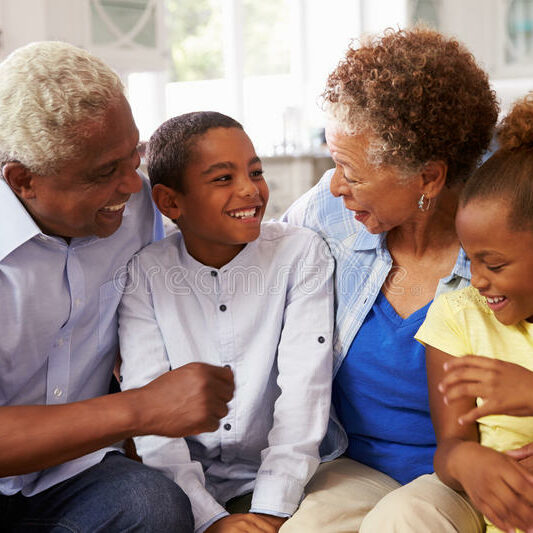 grandparents-their-young-grandchildren-relaxing-home-71523956